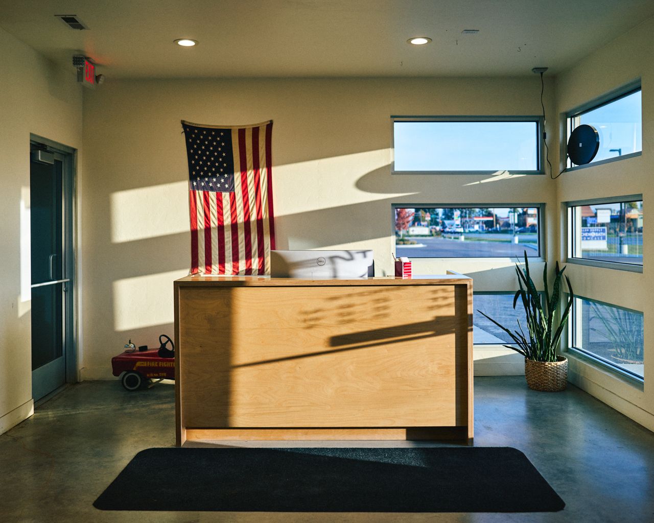 Dent Magic shop lobby with American flag and morning light